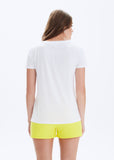 Woman wearing a white t-shirt and yellow shorts on a white background