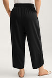 Person wearing black wide-leg pants on a white background