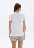 Woman wearing a white t-shirt and light green shorts on a white background