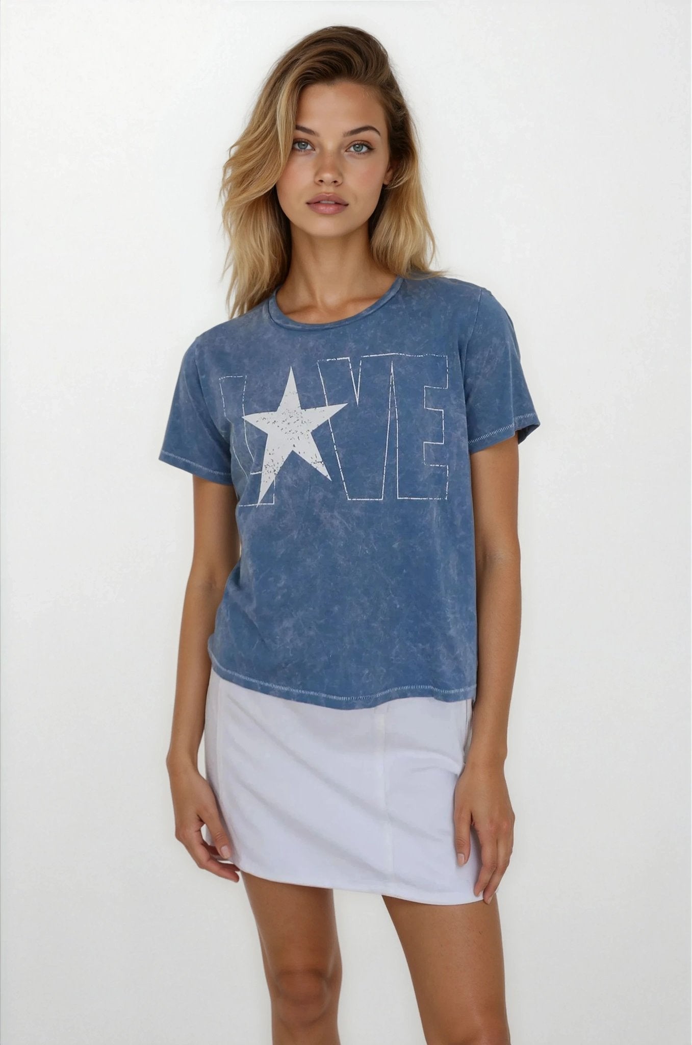 Woman wearing a blue t-shirt with a star and 'LOVE' graphic on a white background