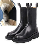 Black leather boots with a close-up inset showing the fluffy lining.