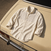 White shirt with purple pattern on a vintage car