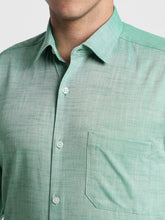 Close-up of a green checkered shirt with a collar and buttons.