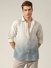 Man wearing a striped shirt with a gradient effect on a plain background