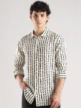 Man wearing a patterned shirt against a plain background