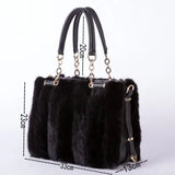 Black fur handbag with gold accents and measurements on a white background