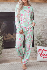 Woman in mint green Christmas Santa print long sleeve jogger lounge set by a fireplace