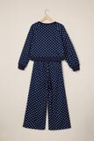 Navy polka dot top and wide leg pant set on a hanger, back view