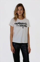 Woman wearing a white t-shirt with 'optimistic Mystic' text on a plain background