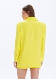 Woman wearing a yellow blazer on a white background