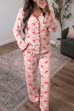 Woman wearing pink Santa print ruffle trim button front Christmas pajama set, front view