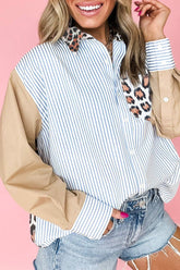 Woman wearing a striped shirt with beige sleeves and leopard print accents on a pink background