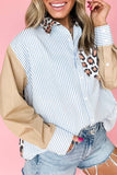 Woman wearing a striped shirt with beige sleeves and leopard print accents on a pink background