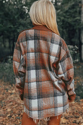 Person wearing a plaid shawl in a forest setting