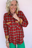 Smiling woman in red-brown plaid shirt with tan trim and bright green pants.