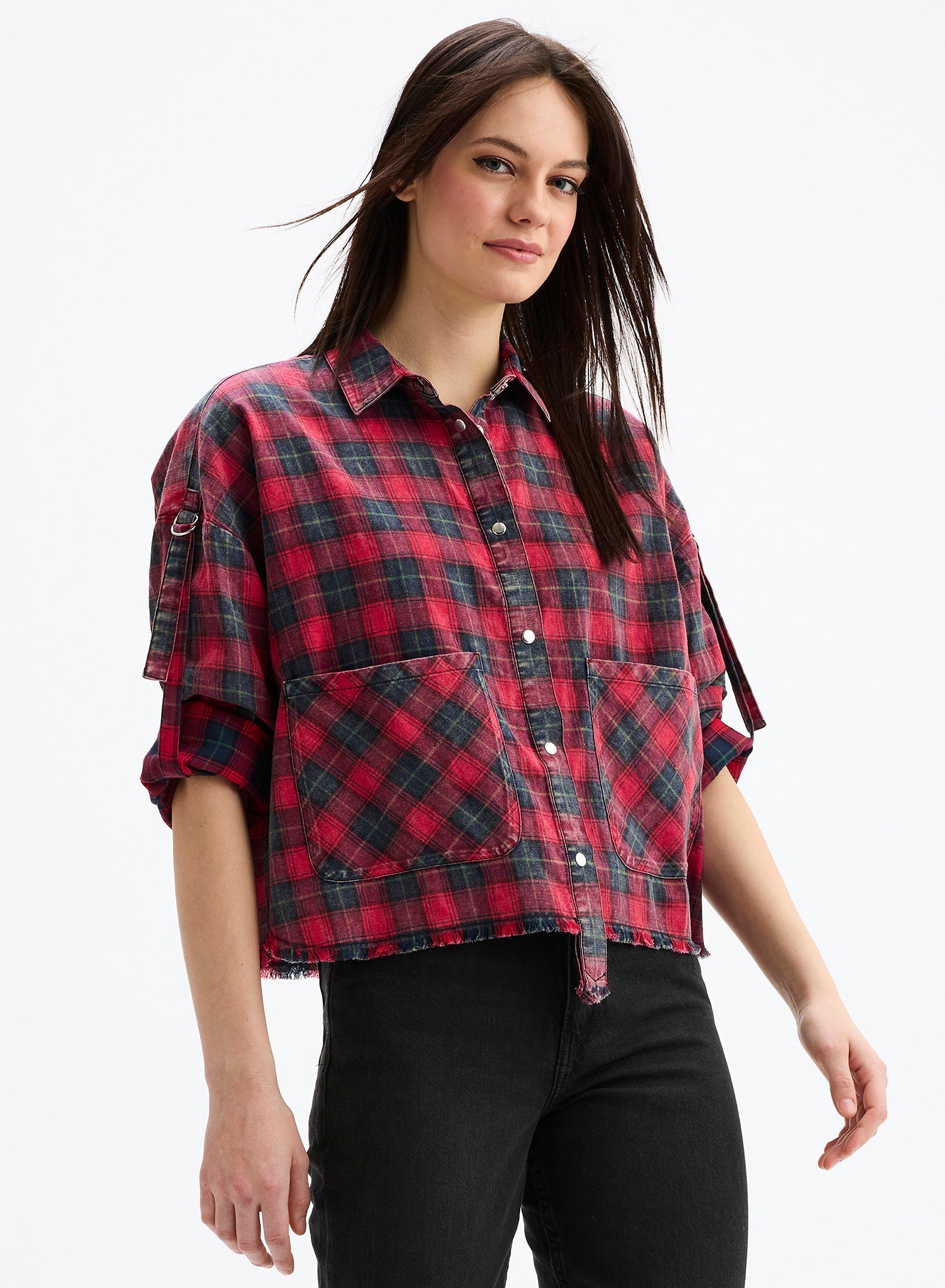 Woman wearing a red and black plaid shirt on a white background