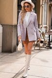 Woman in plaid blazer and white boots walking on a sidewalk with cafe in background