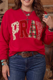 Woman in red “PRAY” patchwork sweatshirt with blue jeans and western jewelry.