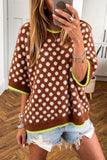 Woman in brown fuzzy polka-dot sweater with neon green trim and denim shorts.
