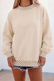 Women's cream oversized sweatshirt with black polka dot trim and balloon sleeves, front view