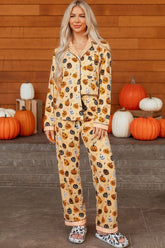 Woman modeling a Halloween pumpkin-print two-piece pajama set.