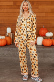 Woman modeling a Halloween pumpkin-print two-piece pajama set.