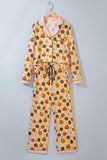 Beige Halloween pajama set with pumpkins, jack-o'-lanterns, and ghost prints on a hanger.