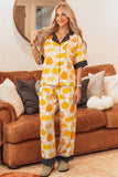 Woman in white pumpkin-print pajamas with black polka-dot trim.