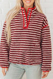 Red and cream striped sherpa snap button pullover with stand collar, worn with light jeans