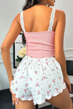 Woman wearing a pink top and floral shorts in an indoor setting.