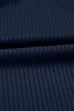 Close-up of dark navy ribbed fabric with a fine vertical stripe texture and a horizontal fold.