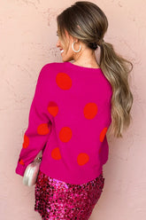 Woman in back view wearing pink polka-dot sweater & skirt.