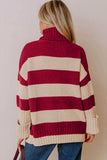Back view of woman in chunky burgundy-cream striped turtleneck sweater and blue jeans.