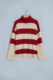 Burgundy-cream striped ribbed turtleneck sweater with cream cuffs and hem on hanger.