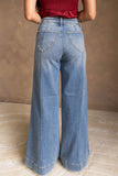 Medium wash flare jeans with back patch pockets and seam detail, back view