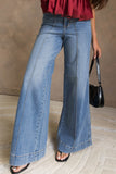 Women's dusk blue high waist flare jeans with front seam detail and heeled sandals, front view
