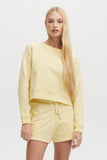 Woman wearing a yellow outfit on a white background