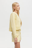 Woman wearing a light yellow outfit on a white background