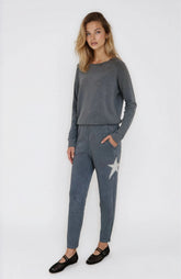 Woman wearing a gray outfit with a star design on a white background