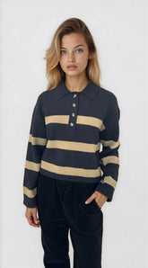 Woman wearing a navy and beige striped sweater on a white background