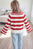 Woman seen from behind in red and white striped knit sweater and light blue jeans in bright bedroom.