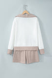White half zip top and striped shorts set on a hanger, back view