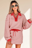 Woman wearing a red and white striped dress with a belt against a beige background