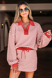 Woman wearing a red and white striped dress with sunglasses indoors.
