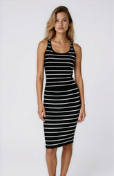 Woman wearing a black and white striped dress on a white background