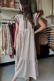 Woman wearing a striped dress in a clothing store