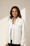 Smiling woman in a textured off-white zip jacket, white top, and black pants.