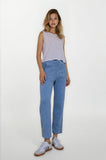 Woman wearing a light purple sleeveless top and blue jeans on a white background