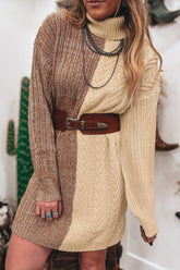 Woman in brown-cream chunky knit sweater dress with brown belt and silver necklaces.
