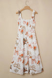 White dress with floral and ribbon pattern on a beige background